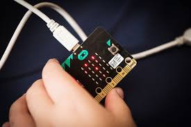 A hand holds a Micro:bit